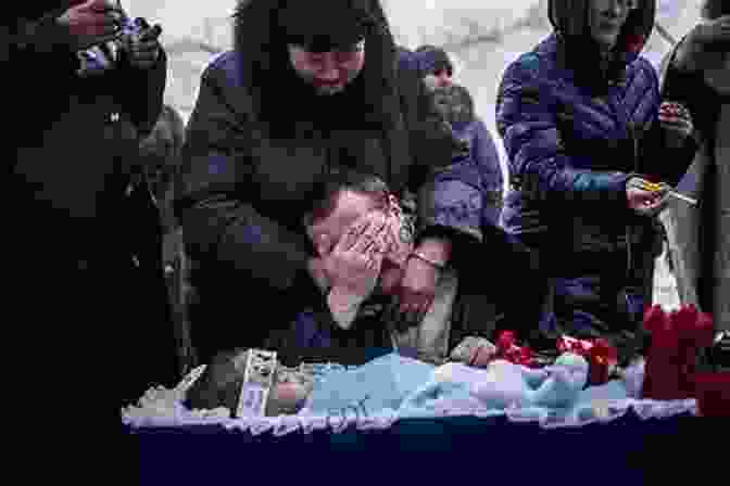 A Group Of Ukrainian Civilians Mourn The Loss Of Loved Ones During A Violent Conflict In Eastern Ukraine. Blood Lands (Savage Lands 5)