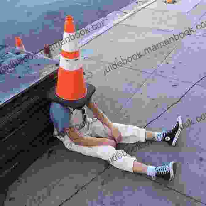 A Man Sitting On A Park Bench With A Traffic Cone On His Head. 76 Shades Of Humor